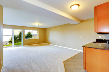 Spacious family room with kitchen cabinets.