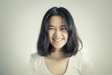 Young Asian woman with smiley face.