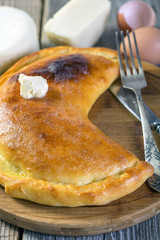 Cheese pie with a slice of butter.