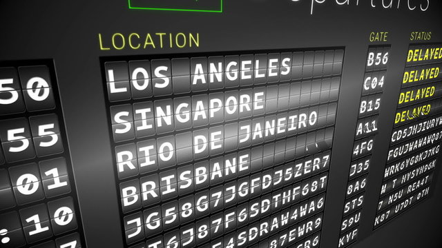 Black departures board showing delayed flights