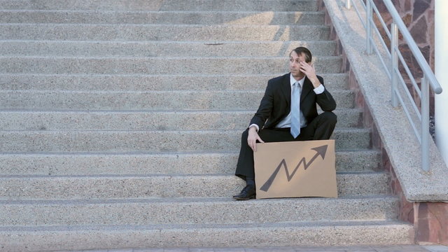 Businessman Sits On Steps Economic Arrow