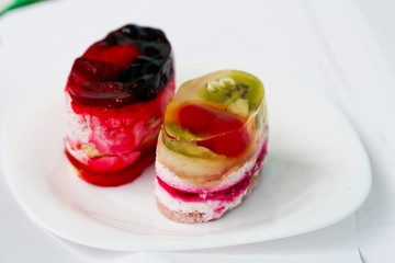 Raspberry cream cakes with jelly, close up