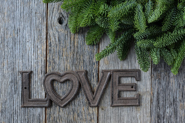 Love for Christmas Text with Pine Needles and Rustic Wood Backgr
