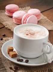 Cup of latte on the old wooden background