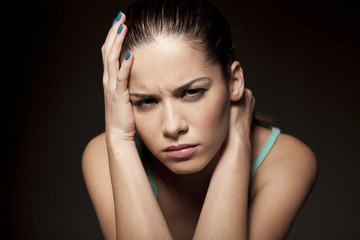 Fototapeta premium portrait of moody angry woman on a dark background