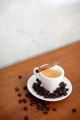 coffee and coffee beans on a wooden table in coffee shop
