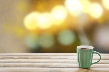Cup of hot drink on bright background