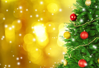 Decorated Christmas tree on festive shiny background