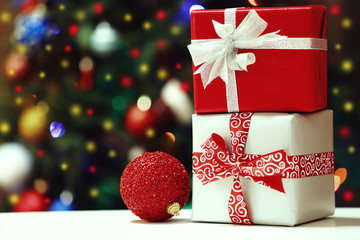 Gift boxes on Christmas tree lights background