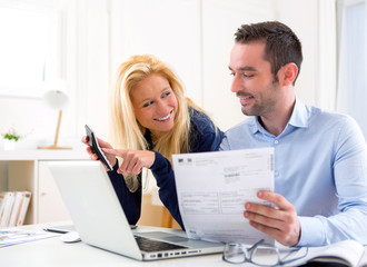 Attractive couple doing administrative paperwork