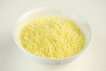 Maize corn flour in white bowl
