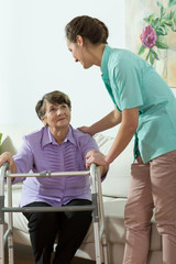 Nurse helping to older lady