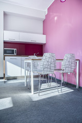 Modern kitchen with pink wall