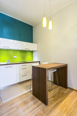 Small dining space in green kitchen