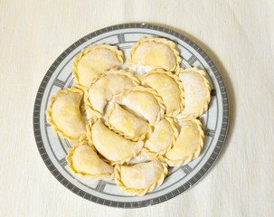 Homemade uncooked ravioli on the plate