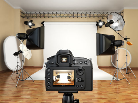DSLR camera in photo studio with lighting equipment, softbox and