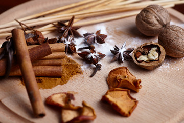 Cinnamon sticks, dried fruit on a wooden board