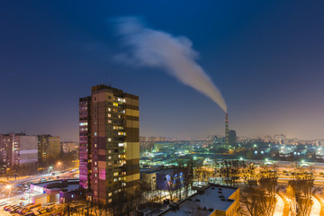 The smoke from industrial pipe in the city at night