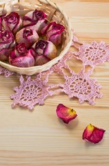 lovely dried roses on the table with light wood