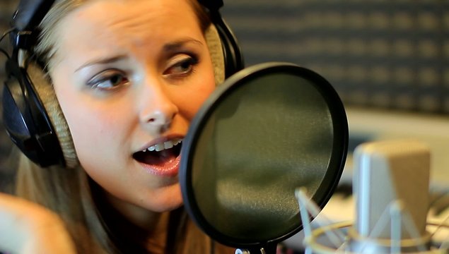 Teen girl sing at the professional audio studio. Portrait view