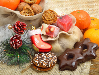 Christmas tangerines, lokum, pinecone and brittle candies on chr