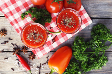 Tomato juice in glasses and fresh vegetables
