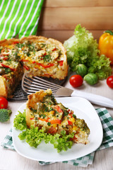 Piece of Vegetable pie with broccoli, peas, tomatoes and cheese
