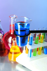 Different laboratory glassware with colorful liquid