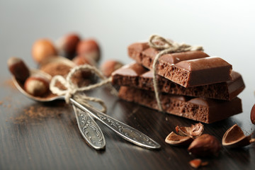 Tasty porous chocolate with nuts on table, close up