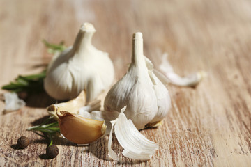Raw garlic and spices on wooden table
