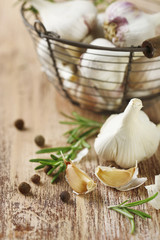 Raw garlic and spices on wooden table