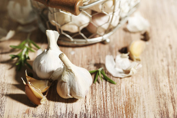 Raw garlic and spices on wooden table