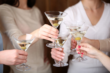 Woman hands with glasses of martini close-up