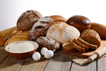 Fresh bread on table on white background