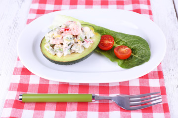 Tasty salad in avocado on plate table close-up