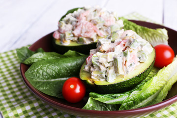 Tasty salad in avocado on plate table close-up