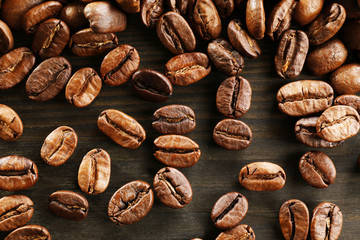 Coffee beans on wooden background, close-up