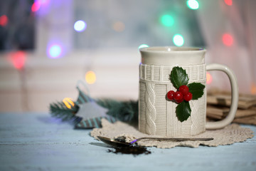 Christmas composition with cup of hot drink, on wooden table