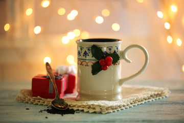 Christmas composition with cup of hot drink, on wooden table