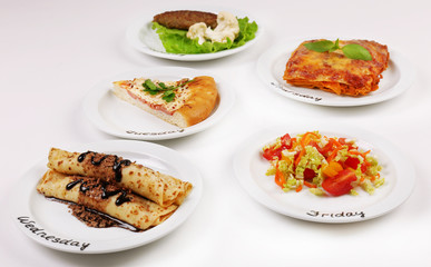 Daily menu. Plates with food on table