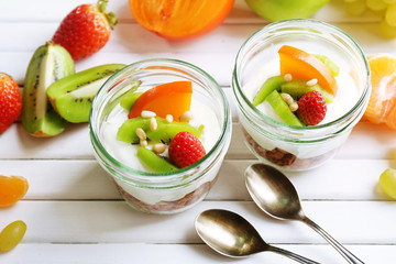 Healthy dessert with muesli and fruits on table