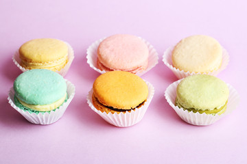 Set of gentle colorful macaroons on color background