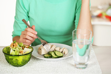 Girl and dietary food at table close-up