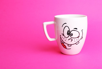 Emotional cup on pink background