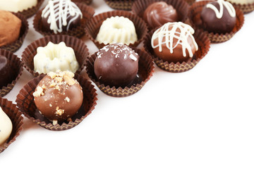 Delicious chocolate candies on white background
