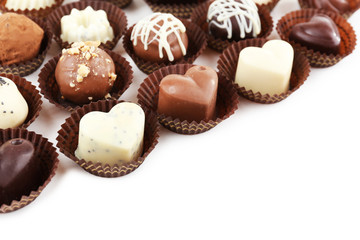 Delicious chocolate candies on white background