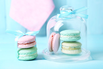 Gentle colorful macaroons in glass bell jar
