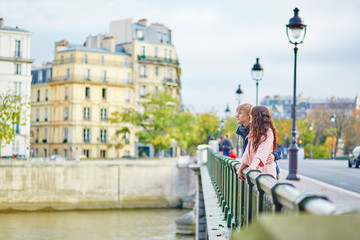 Happy dating couple walking in Paris