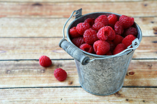 Fresh raspberries in a small bucket