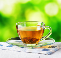 Cup of tea on nature background